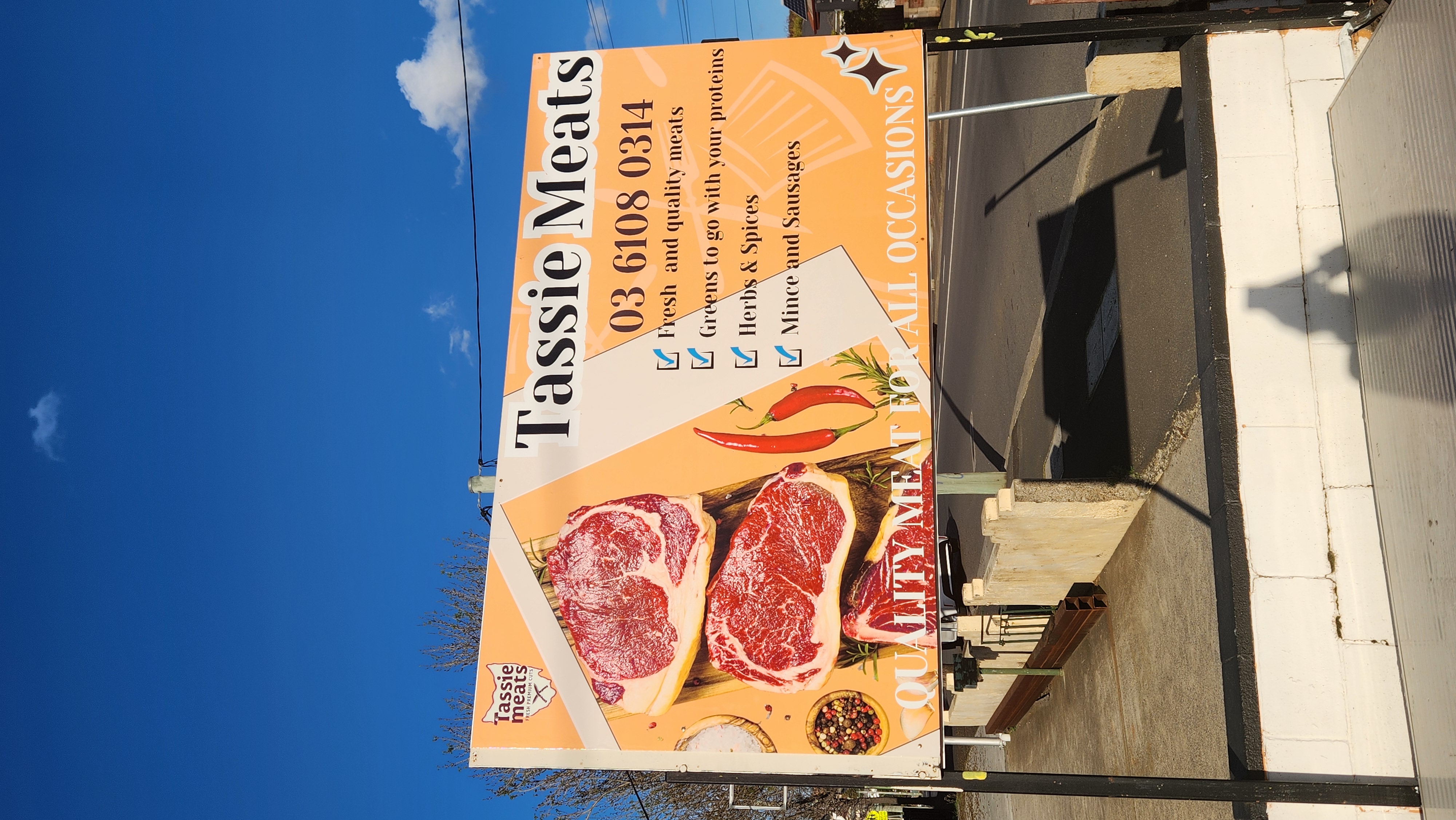 Tassie Meats sign advertising fresh quality meats, vegetables, herbs and spices